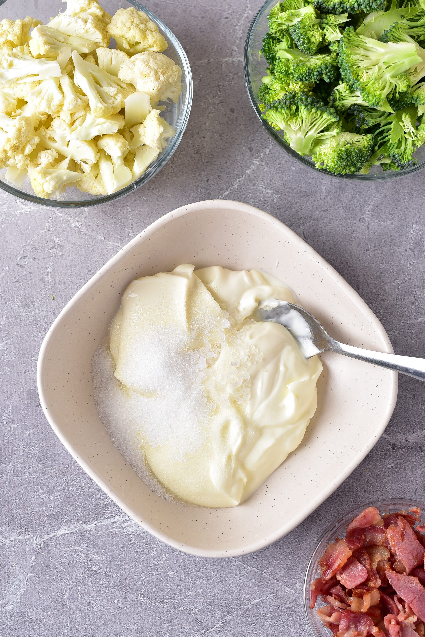 In a small bowl, stir together the sour cream, mayonnaise, sugar, and salt. 