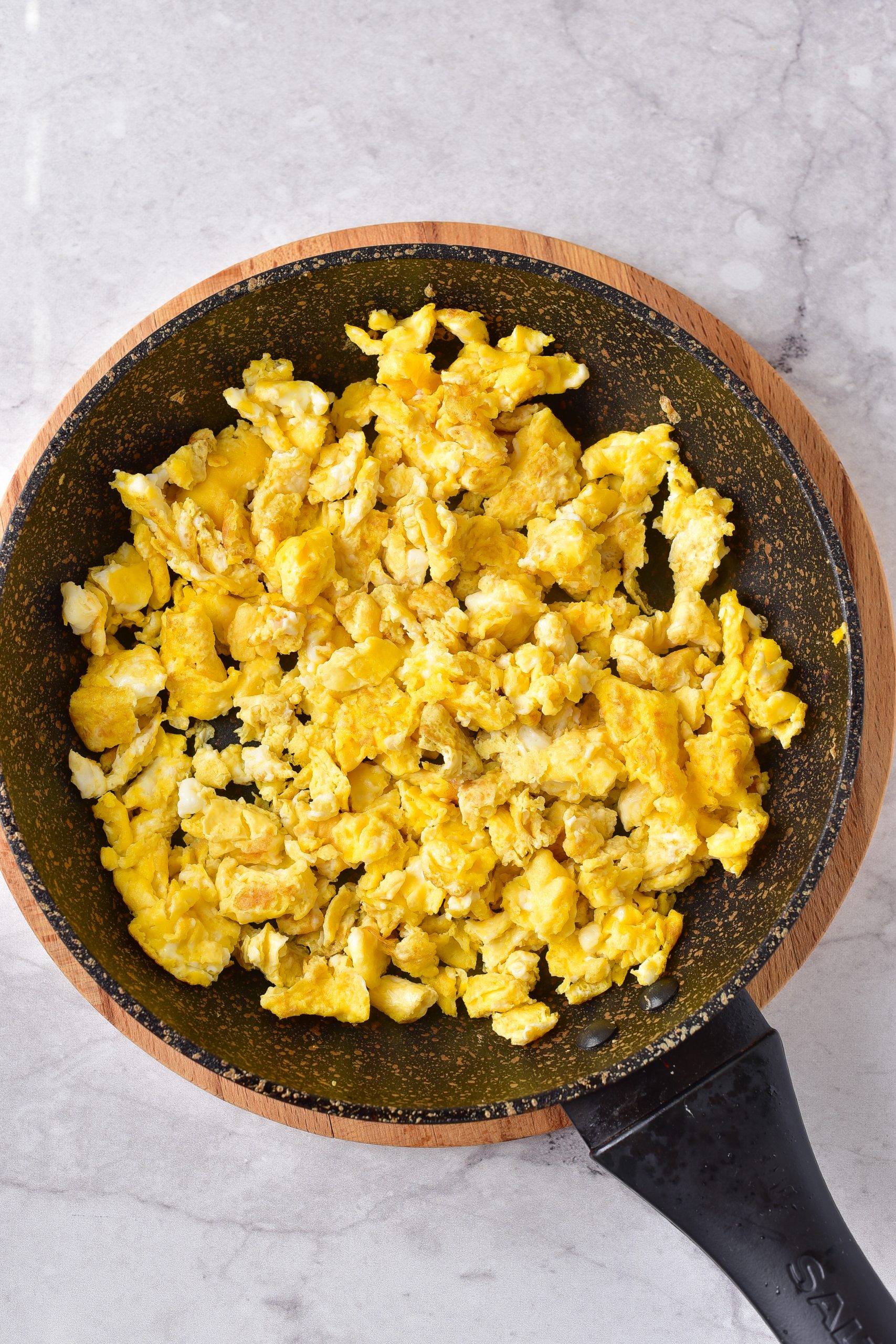 Add your eggs to another skillet over medium heat, and scramble to your liking. 