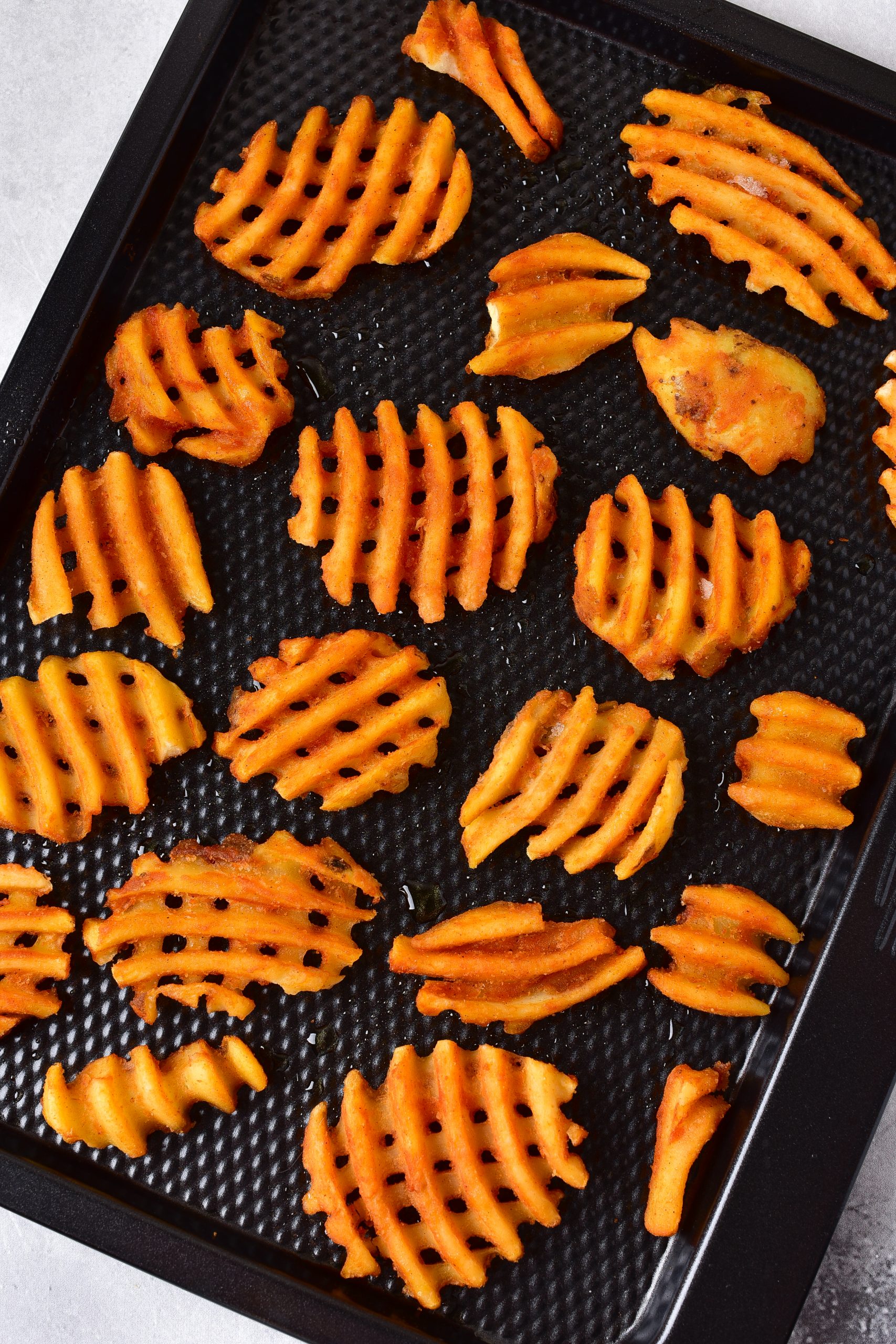 Layer the waffle fries on a baking sheet, and bake in a 400-degree oven according to the package instructions. 