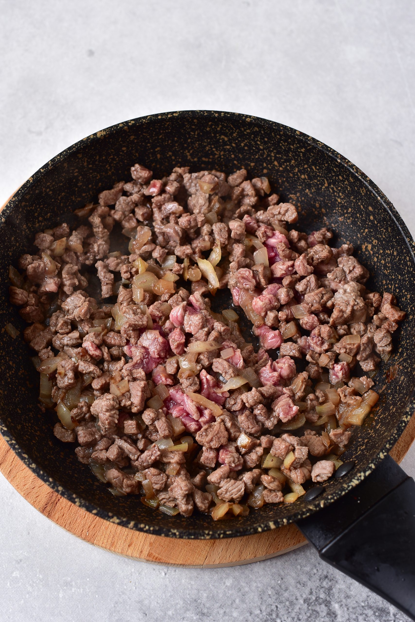Stir in the ground beef, and saute until completely browned. Drain the excess far.