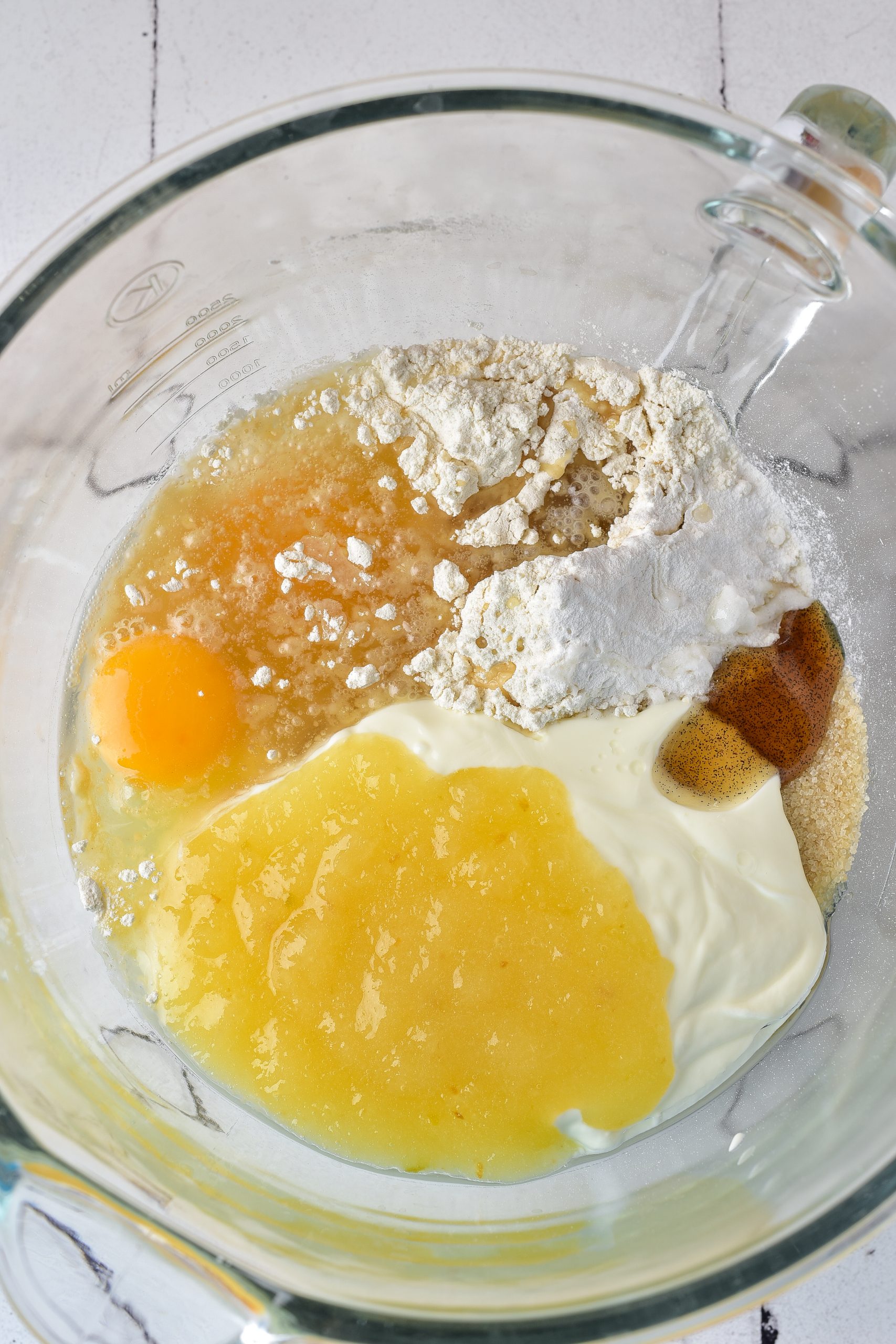 Beat together the eggs, applesauce, vanilla, eggs, Greek yogurt, baking powder, salt, and baking soda until smooth. 