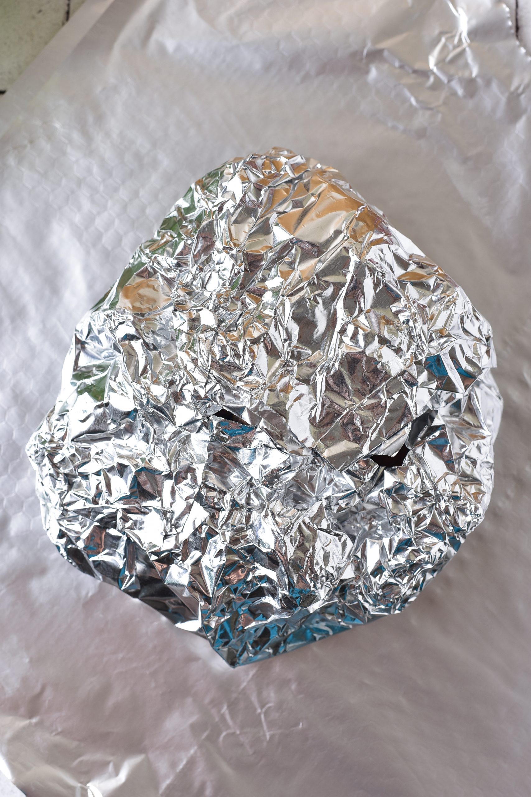 Fold the edges of the foil squares up to form a closed packet. 