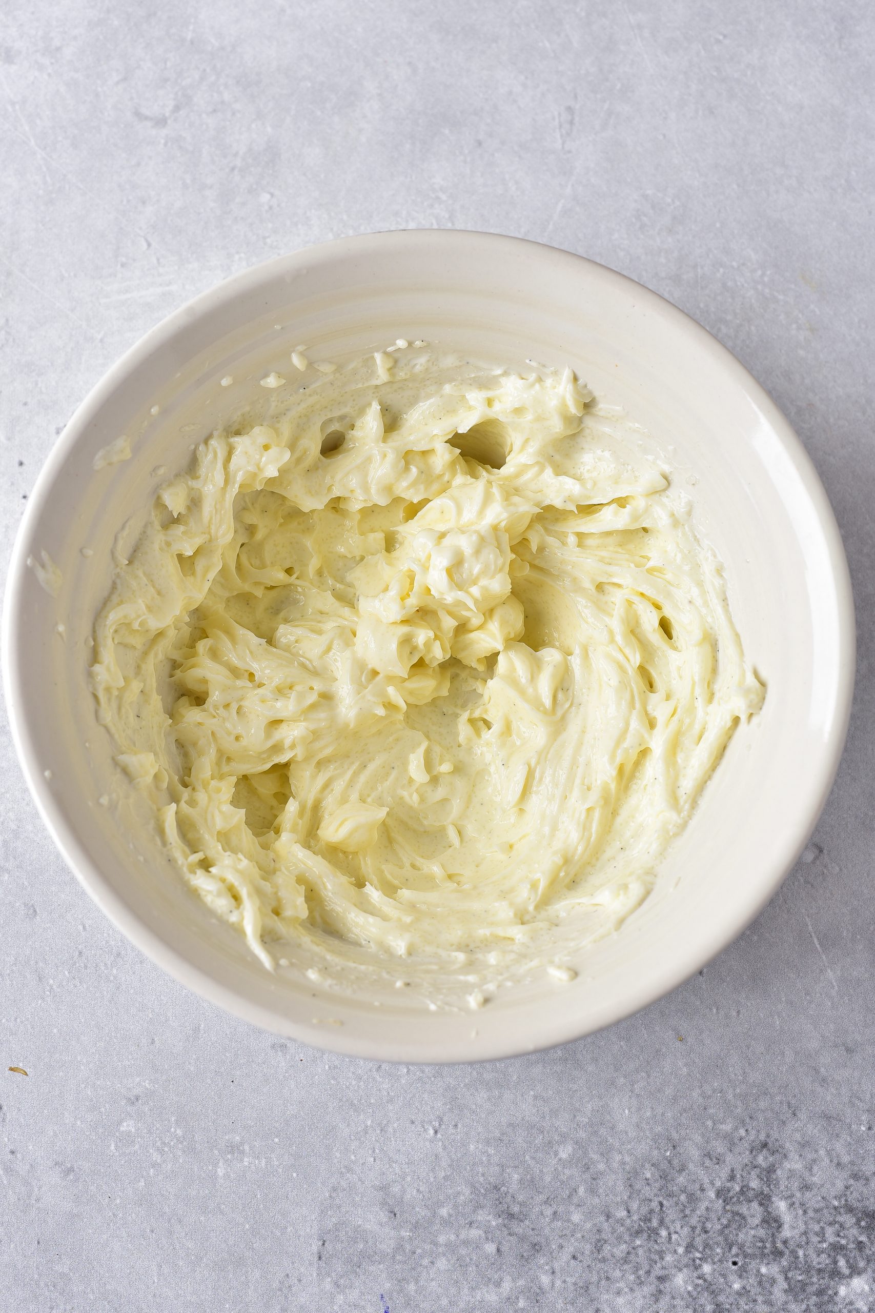 In a mixing bowl, combine the cream cheese, vanilla, and sugar until smooth and creamy. 