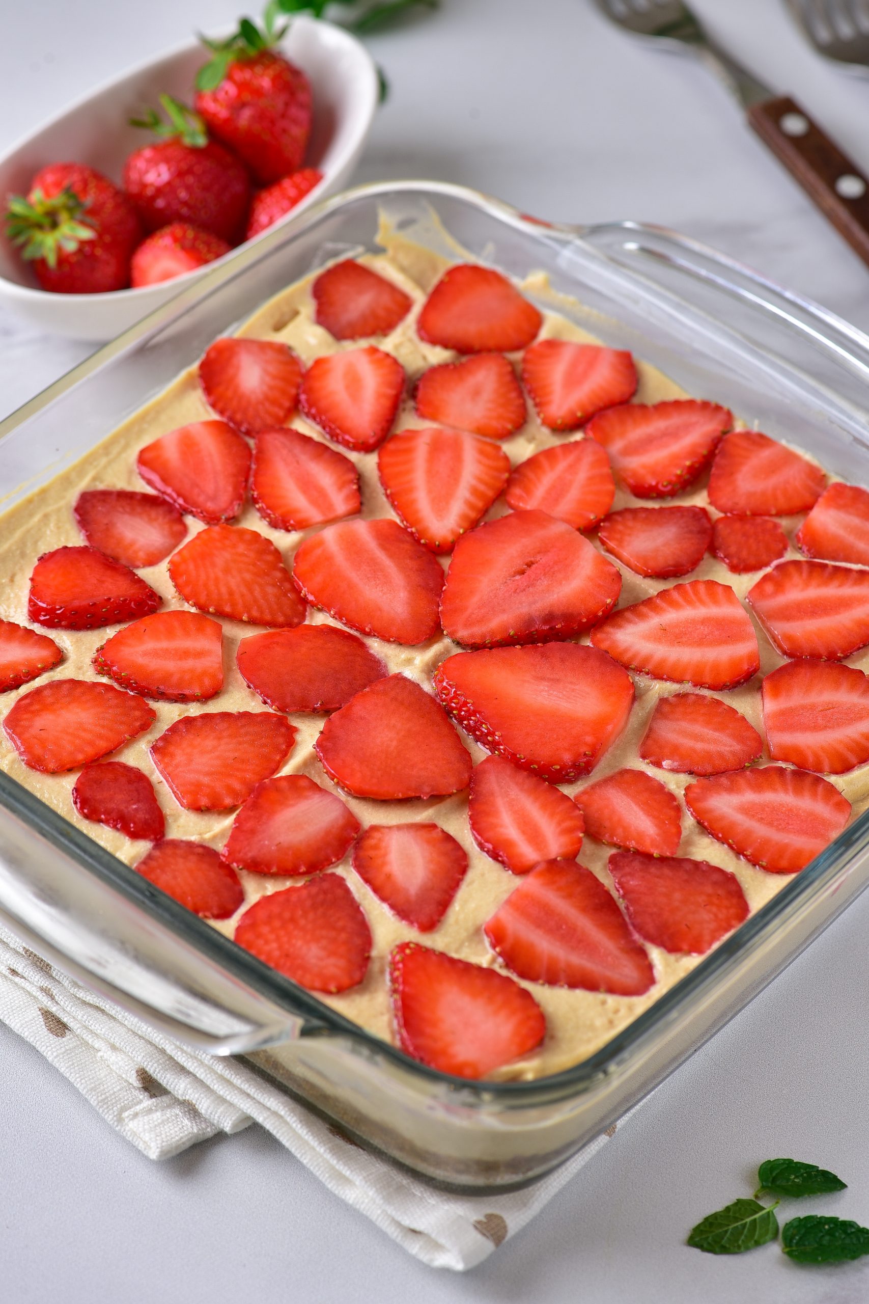 Spread the remaining cheesecake mixture into the pie plate, and top with the remaining strawberries. 