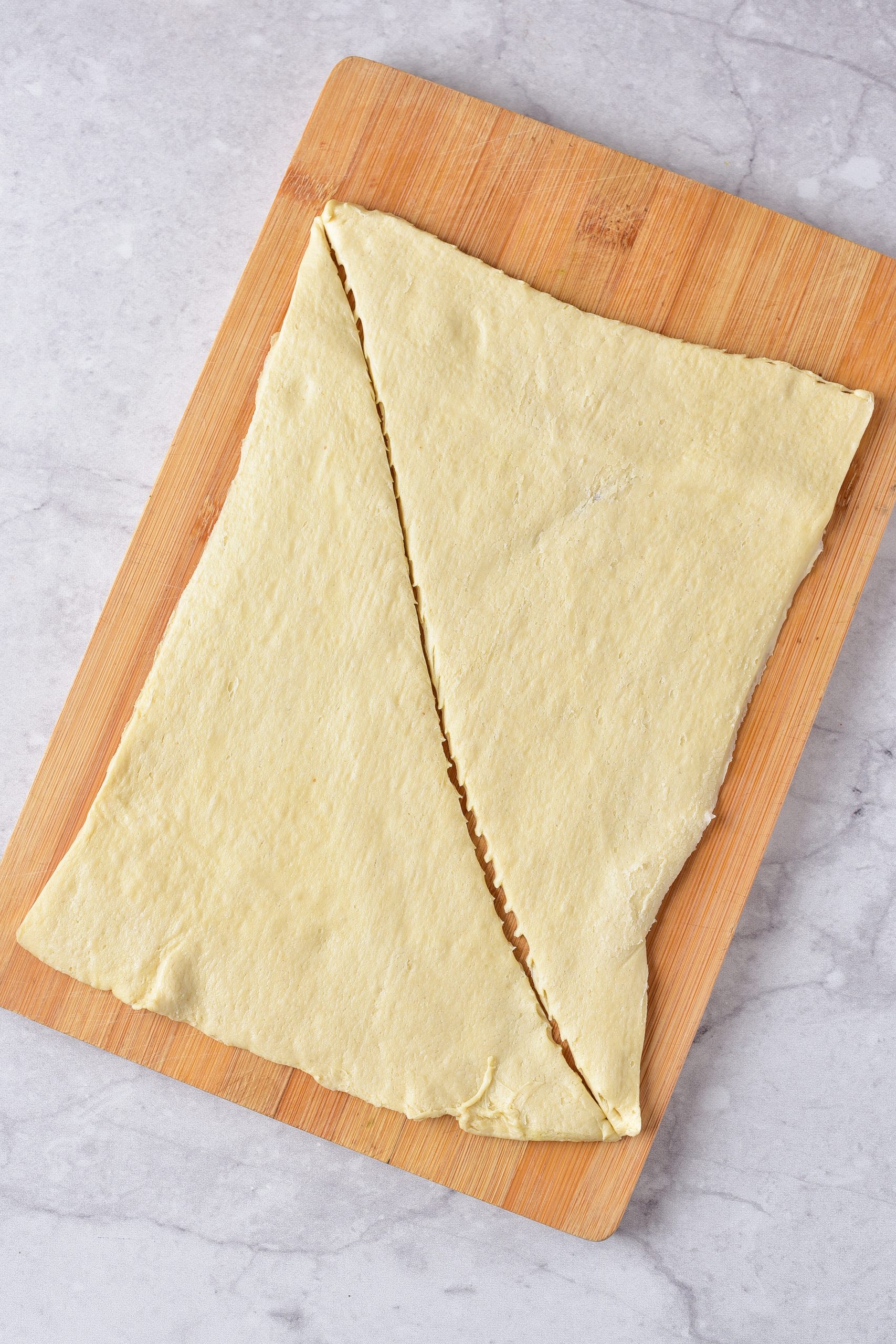 Unroll the crescent roll dough, and separate it into triangles. 