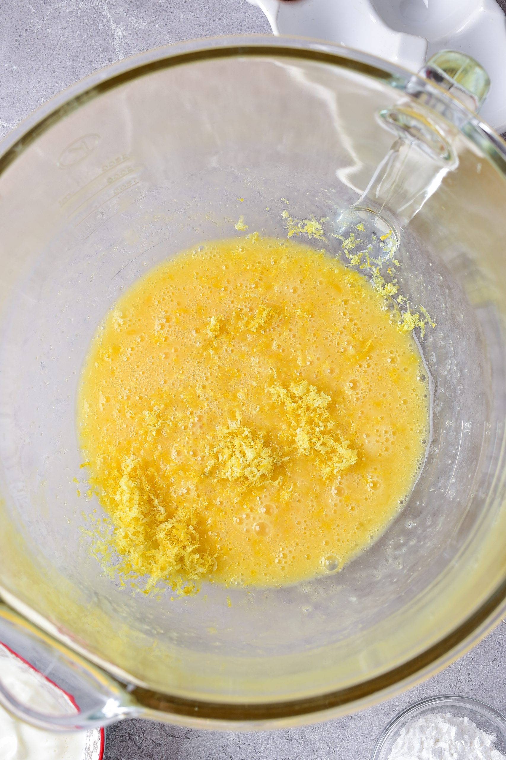 Blend together the eggs, sugar, lemon zest, and lemon juice until well combined. 