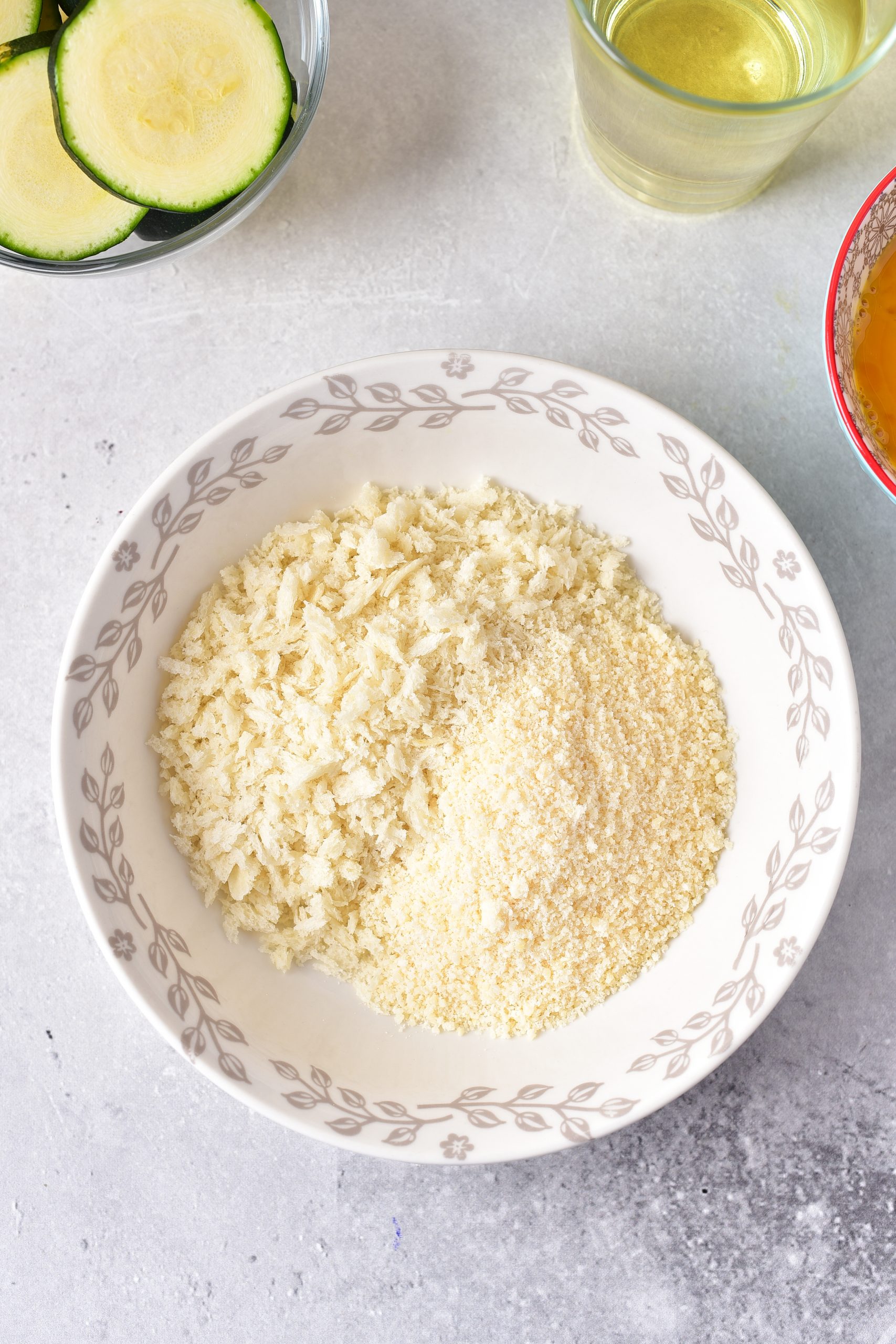 Add the flour to one shallow bowl, the beaten eggs to another, and the panko and parmesan cheese together in a third.