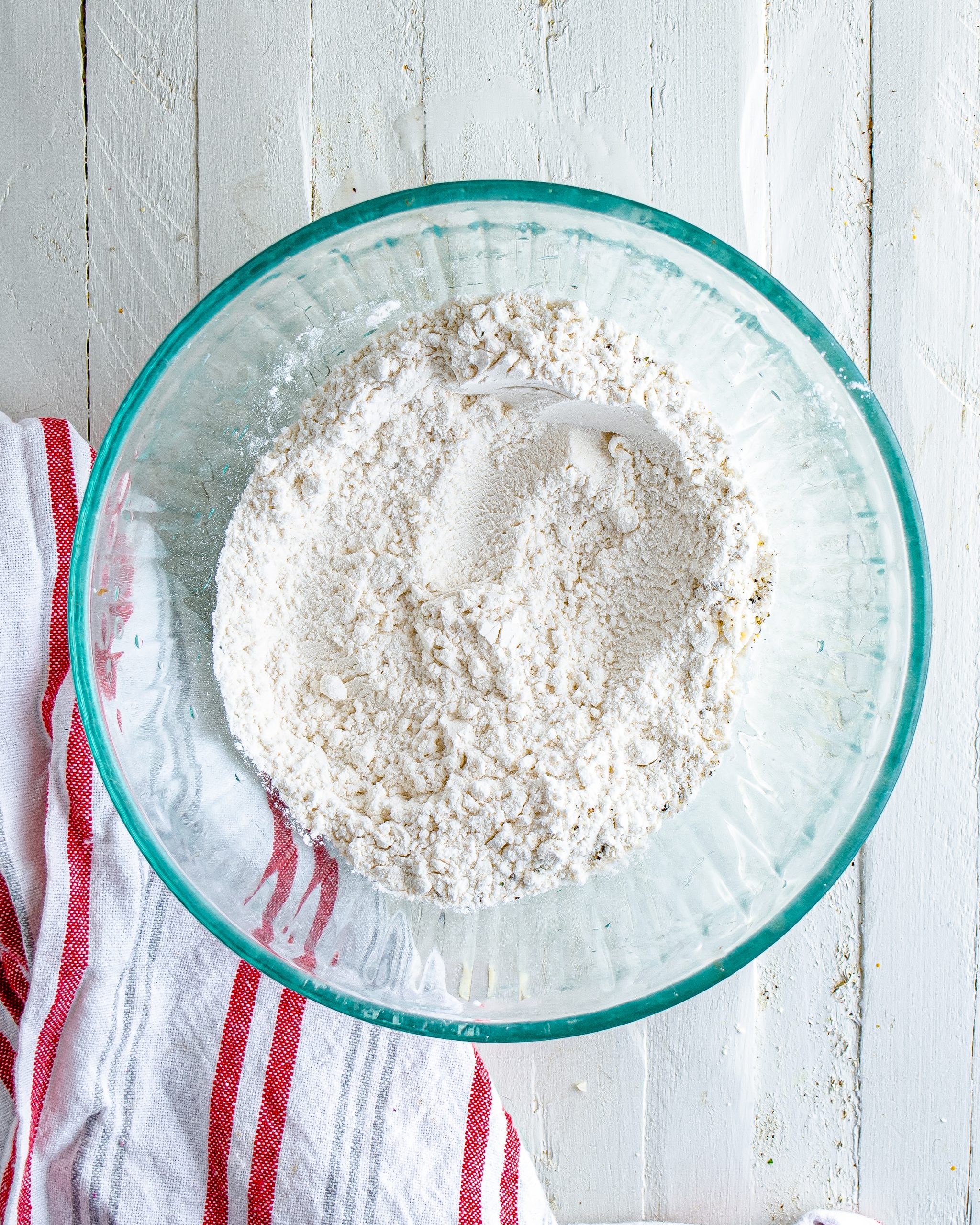 Add the flour to a separate shallow bowl, and season with salt and pepper. 