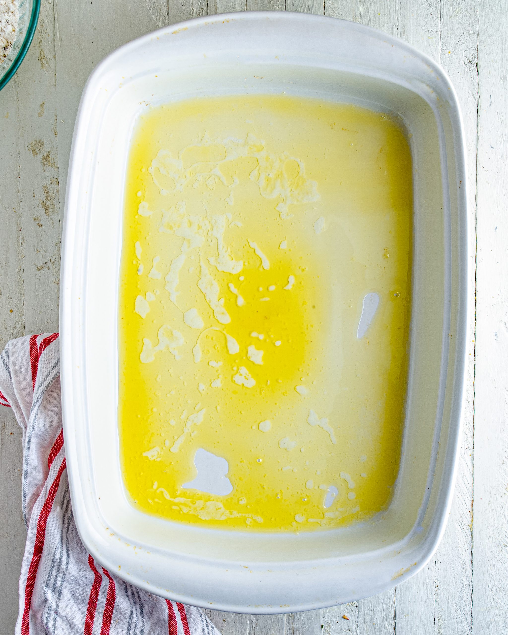 Melt the butter, and place it into the bottom of a 9x13 baking dish.