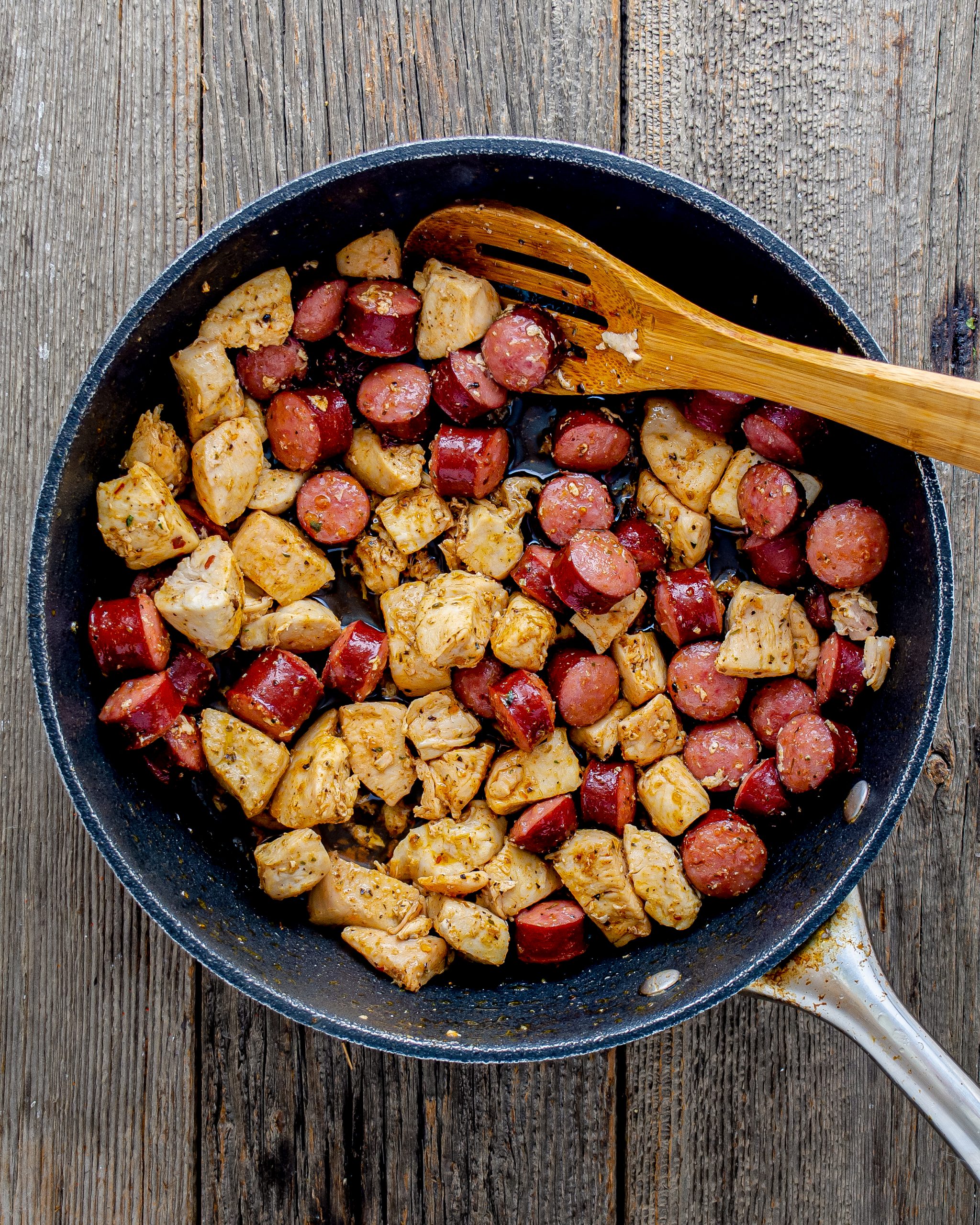 Season the chicken with the creole seasoning, and add to the heated skillet with the sausage. Saute until the chicken and sausage are cooked through.