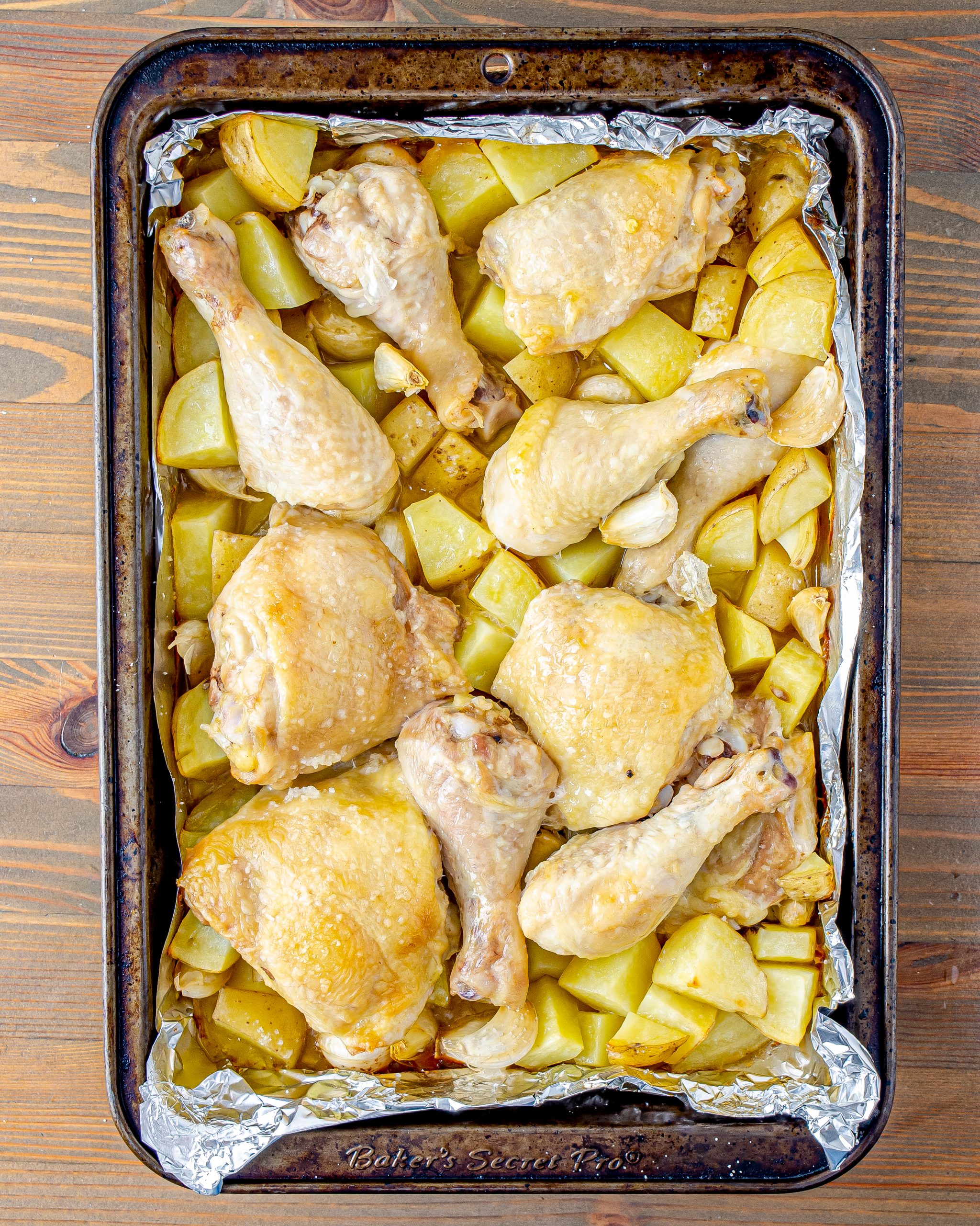 Add the potatoes, garlic, and chicken to the baking dish.