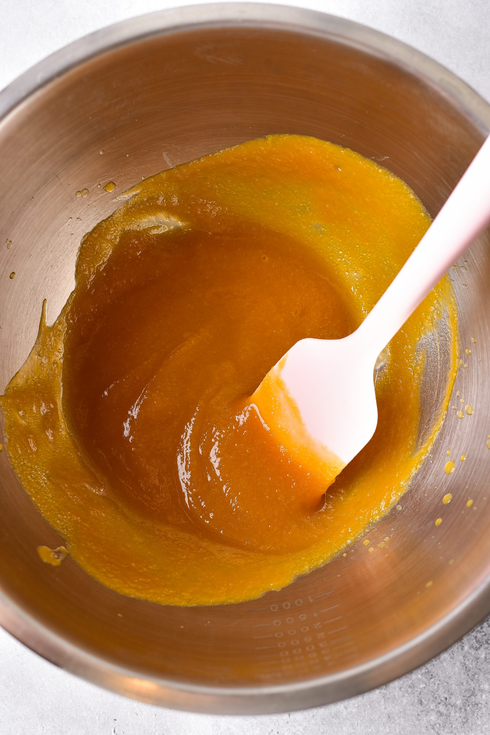 Blend together the sugar, brown sugar, and pumpkin puree in a bowl. 