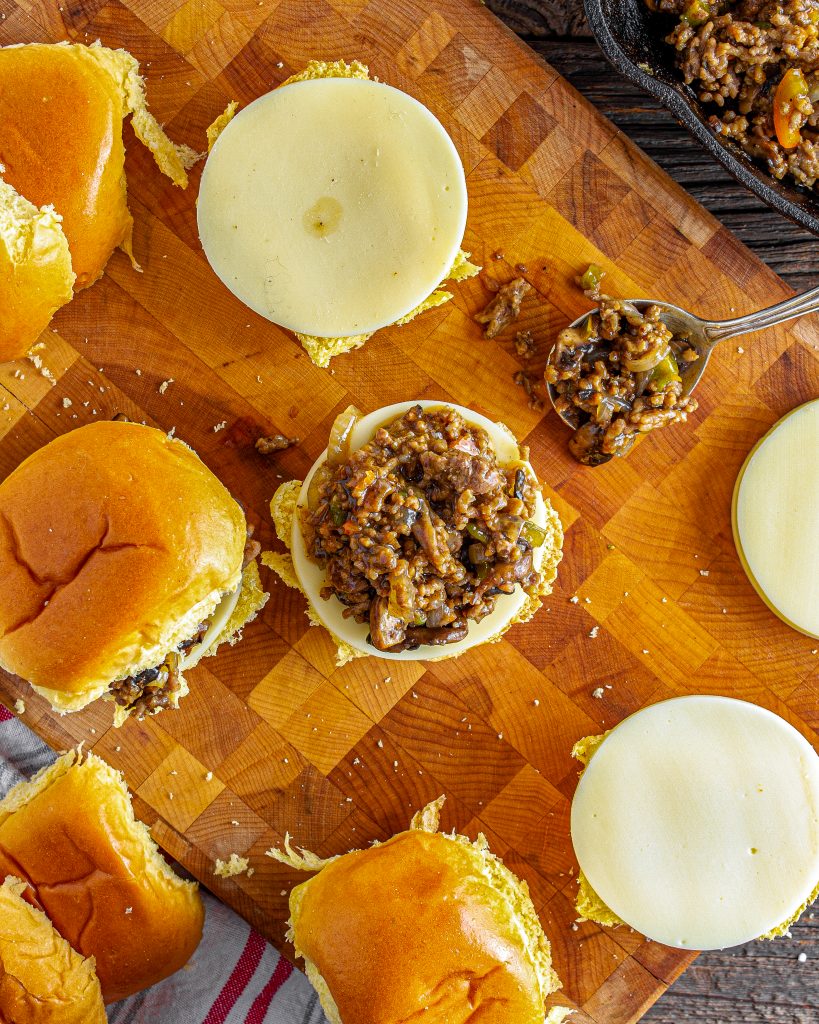 Spoon the meat mixture into the buns, top with the cheese, and broil for 1-2 minutes before serving.