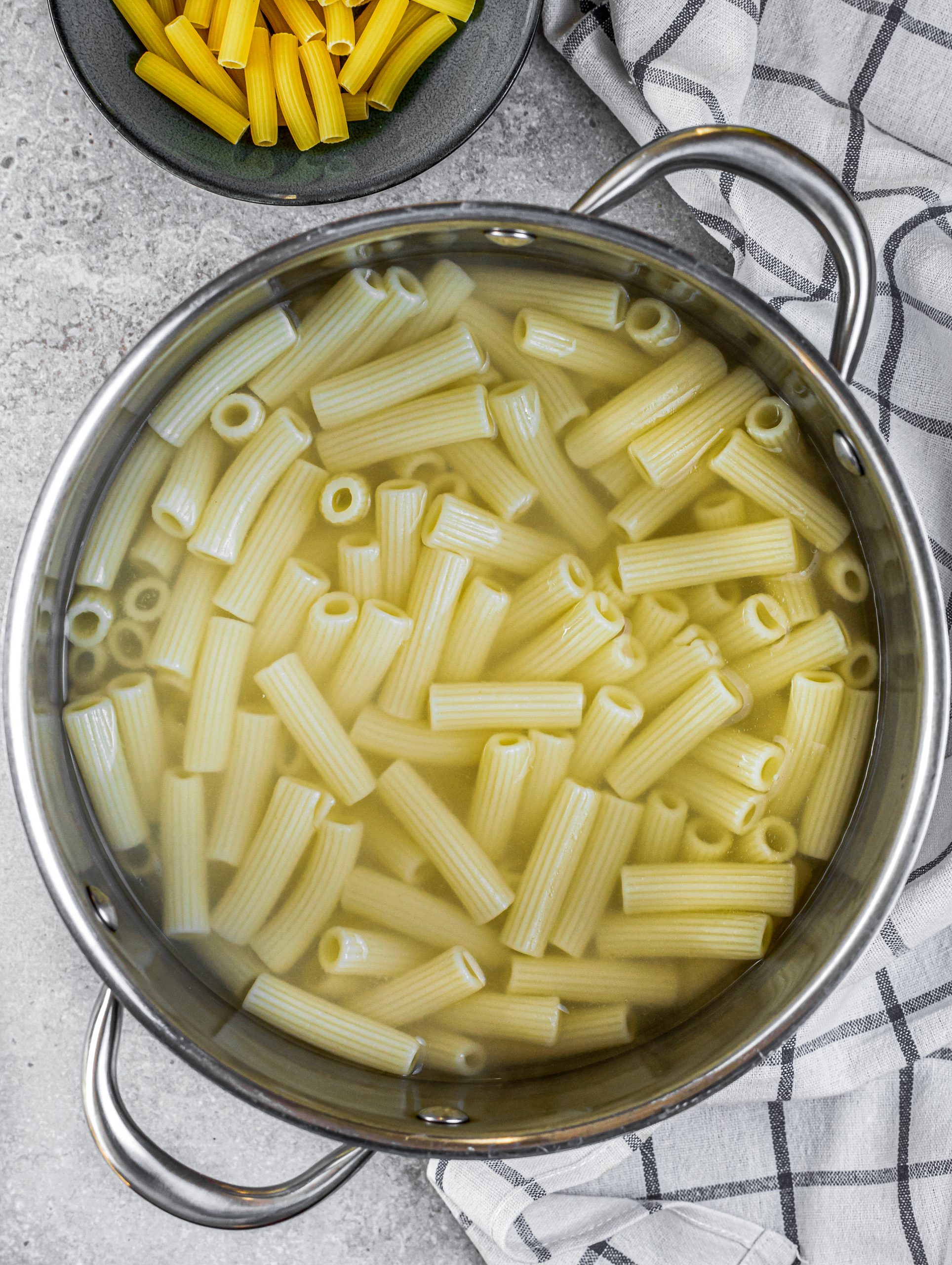 Cook the rigatoni in a pot of boiling water until done to your liking. Reserve ½ cup of the water, and drain the pasta well.