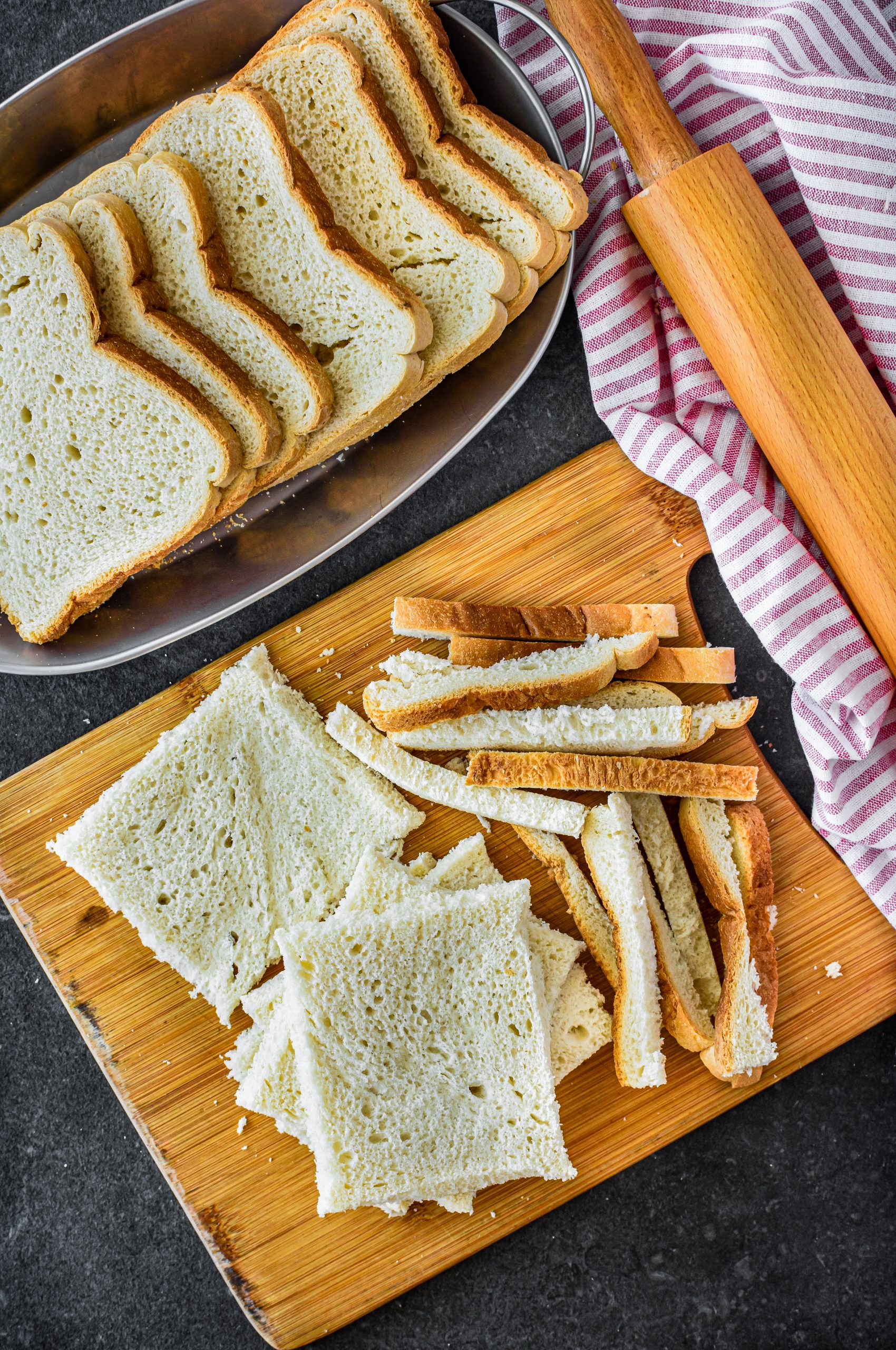 Slice the crust off of each piece of bread, and roll the slices flat with a rolling pin. 
