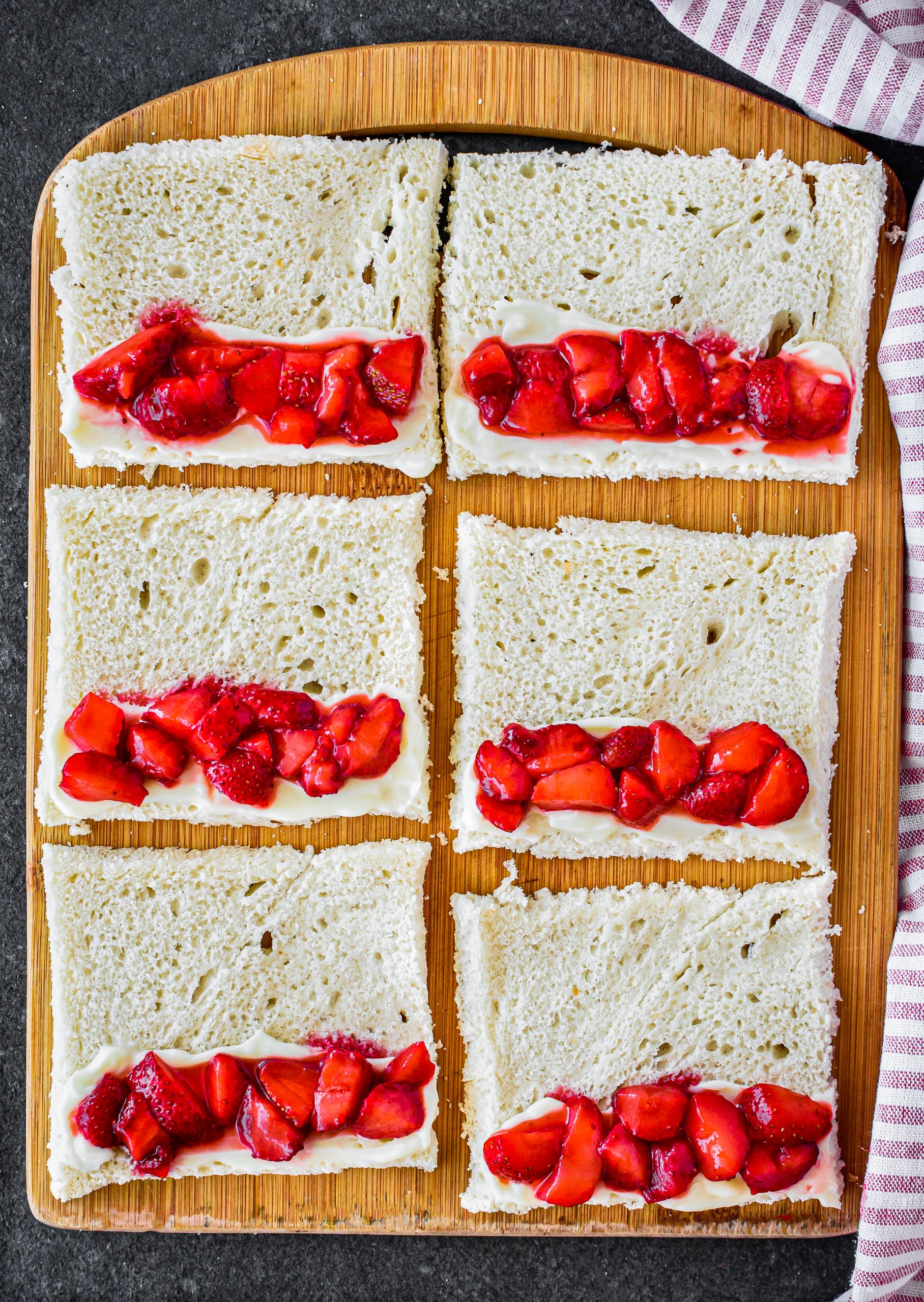 Sprinkle the strawberries over the same half of the bread. 