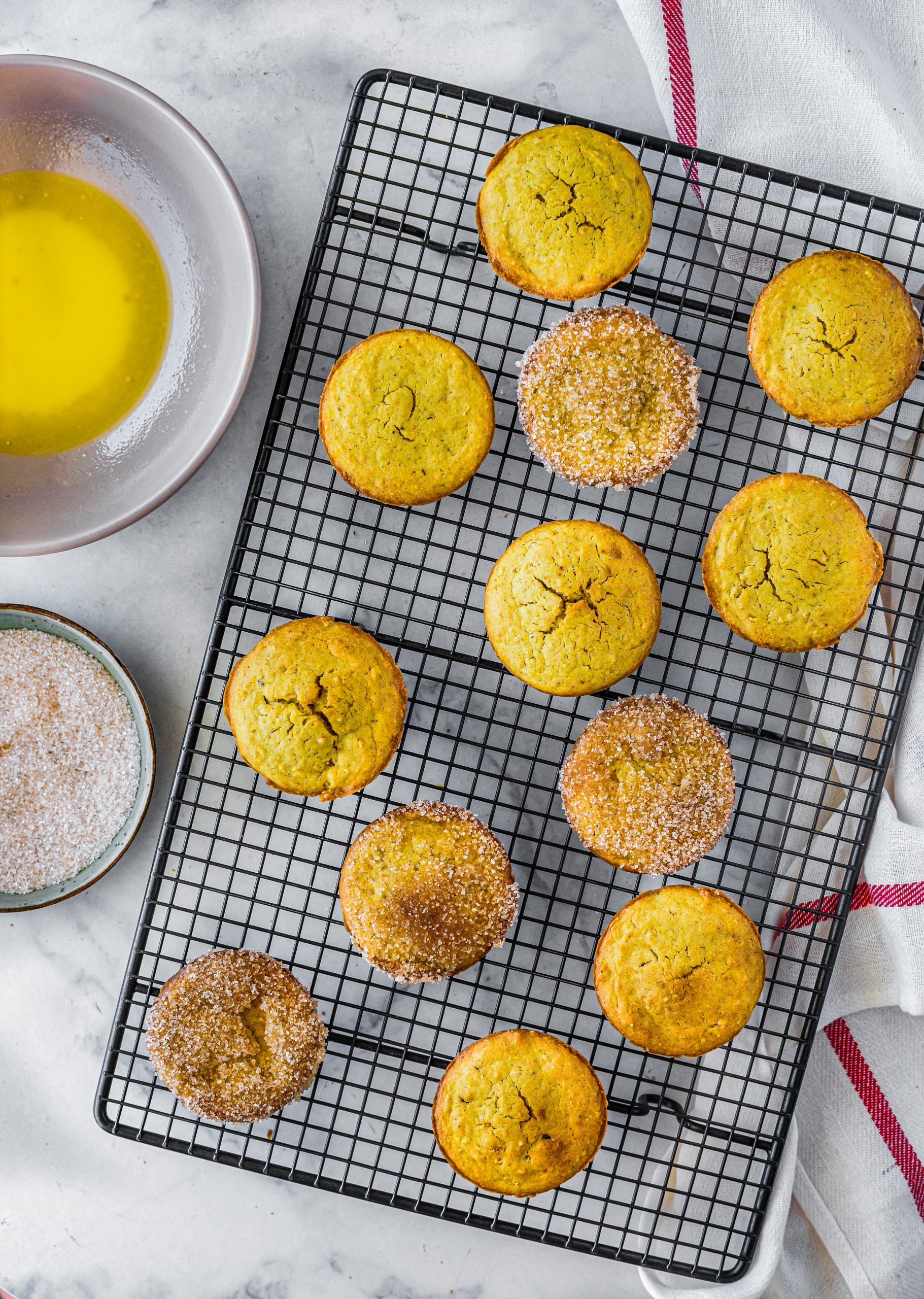 Dip each muffin into the butter, and then roll in the sugar mixture before serving. 