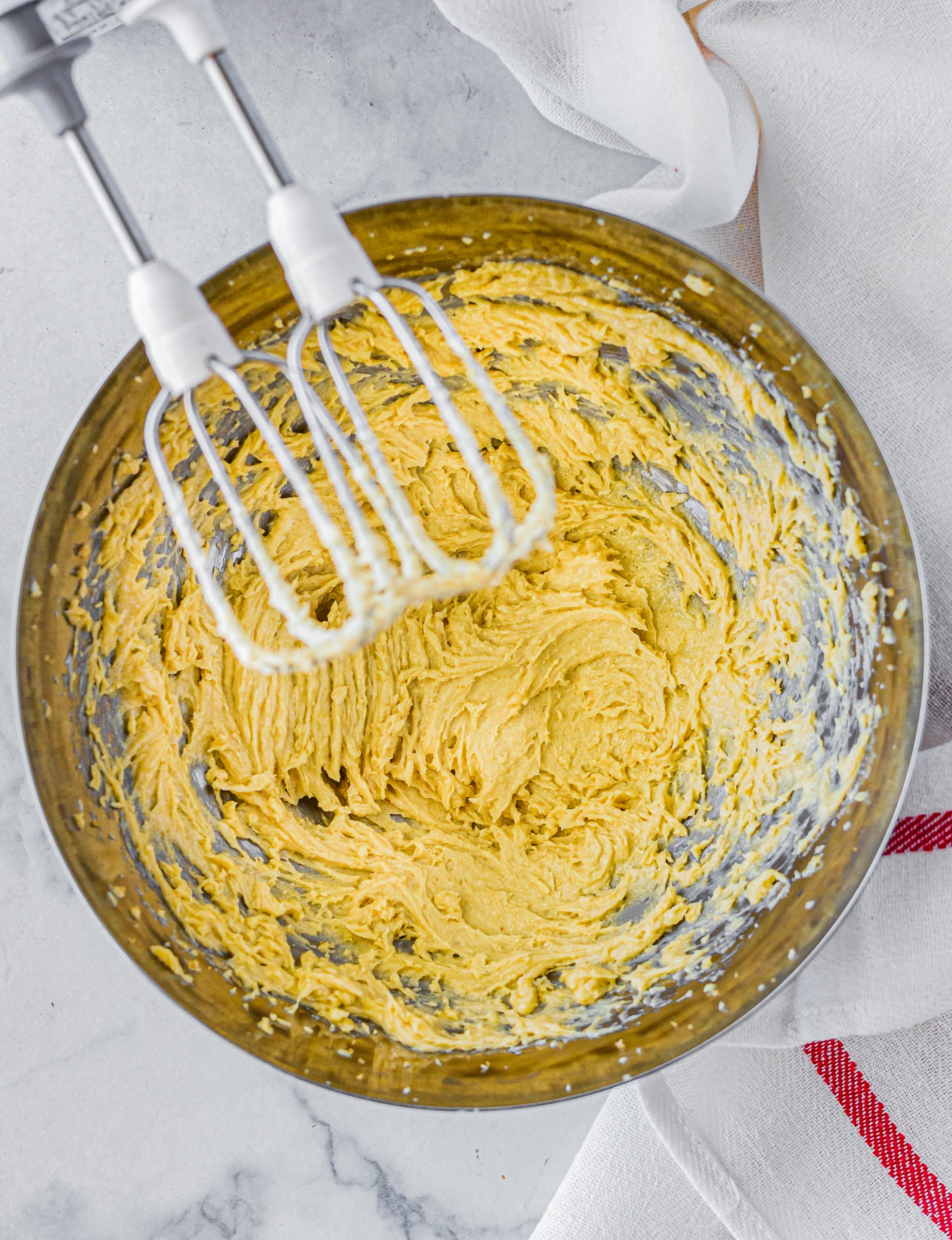 In a separate bowl, blend together the butter and sugar until creamy. 