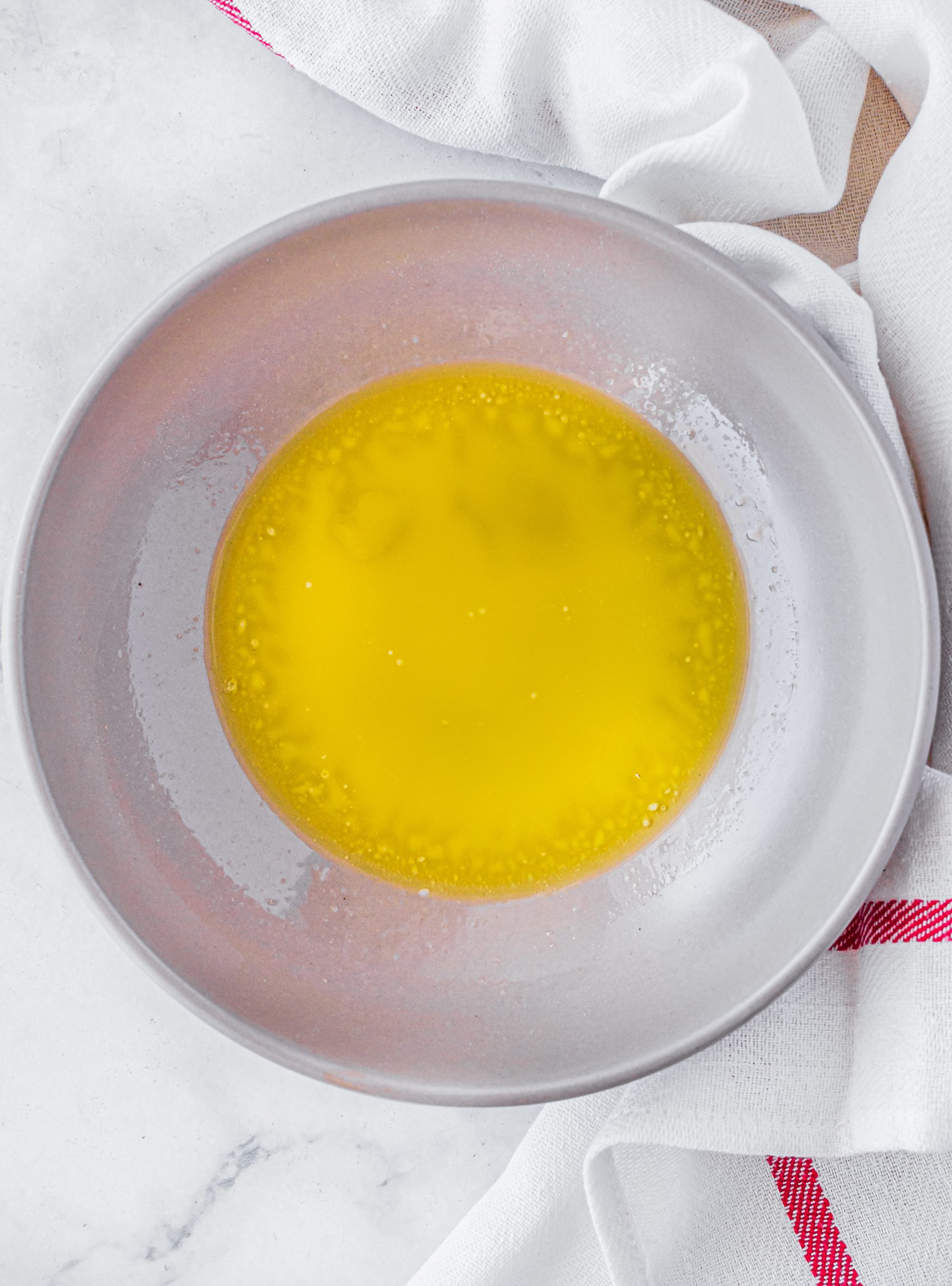 Add the melted butter for the topping into a shallow bowl. 