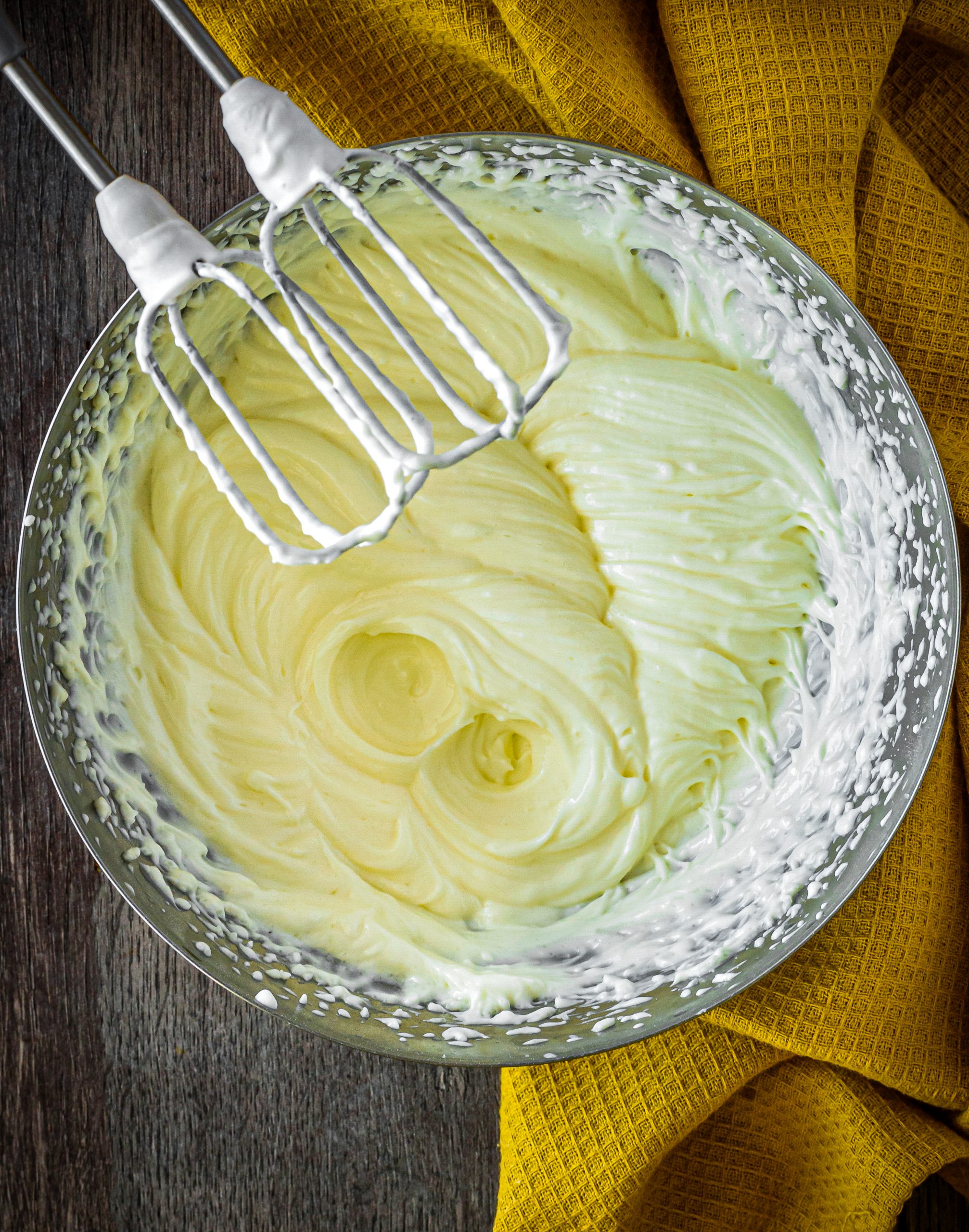 In a separate bowl, whisk together the heavy whipping cream and 2 Tbsp of powdered sugar until stiff peaks form. 